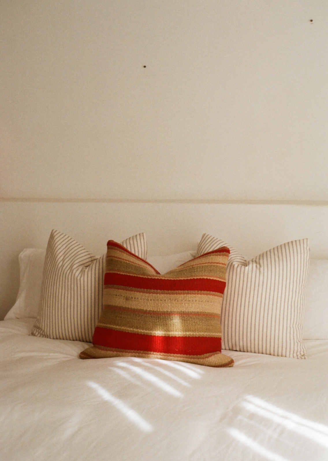 Red and teal striped cushion cover