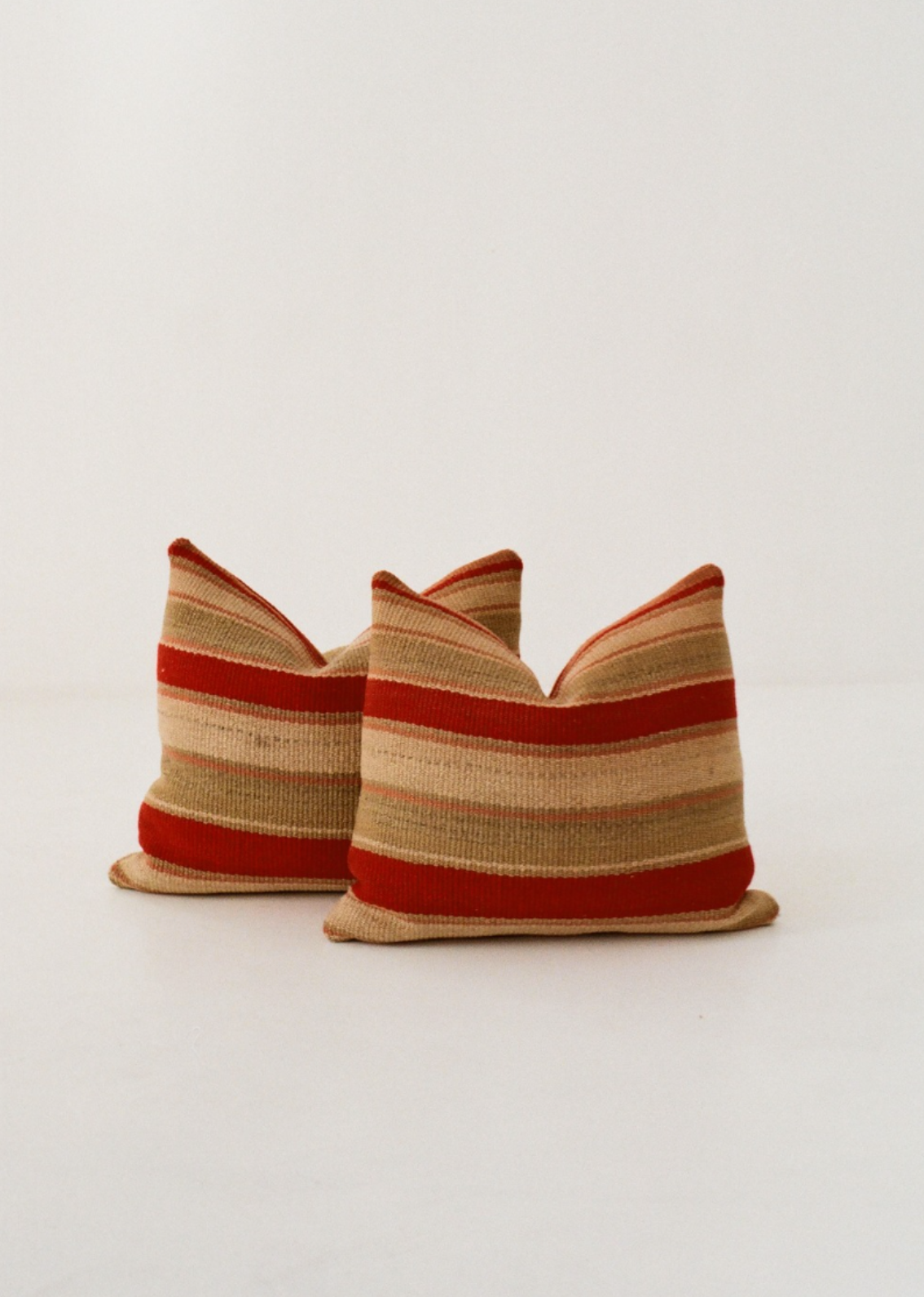 Red and teal striped cushion cover